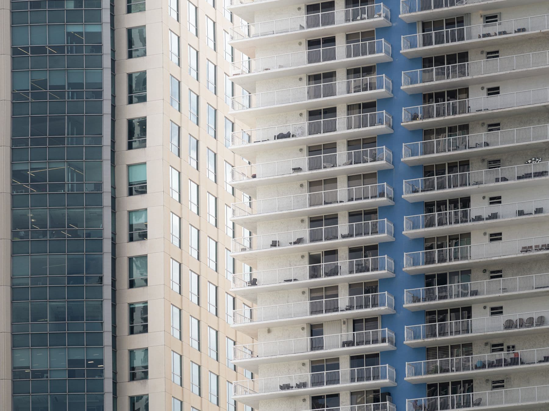 Balconies and glass on the facades of high-rise residential towers in Miami.